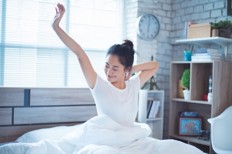 How HVAC Effects Sleep - Asian women She is in bed and was waking up in the morning. She felt very refreshed.